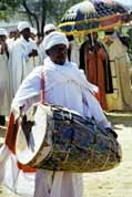 Drumming priest at procession during Timkat. Lalibela. North, Ethiopia.