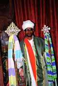 Stone church at Lalibela. Priest shows holy crosses. North, Ethiopia.