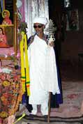 Stone church at Lalibela. Priest shows holy crosses. North, Ethiopia.