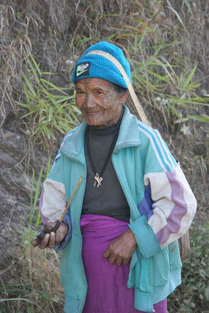 Woman from Munn Chin tribe, around Mindat village, Chin State. Pipe smoking is very popular among Chin people. Myanmar (Burma).