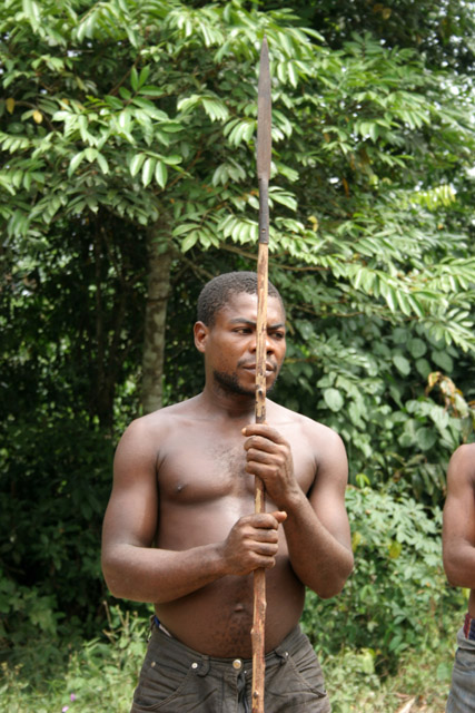 Pygmy hunter, village down to the Lobe River. The Pygmy people are gatherers and hunters. They hunt animals such as antelopes, pigs and monkeys, and also gather honey, wild yams, berries and other plants. Cameroon.